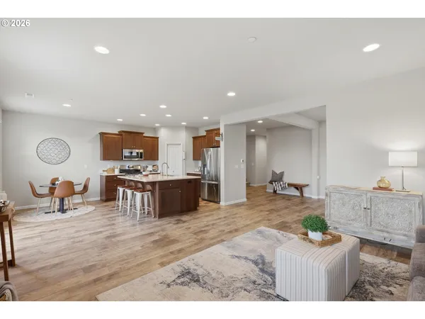 a living room with furniture and kitchen view
