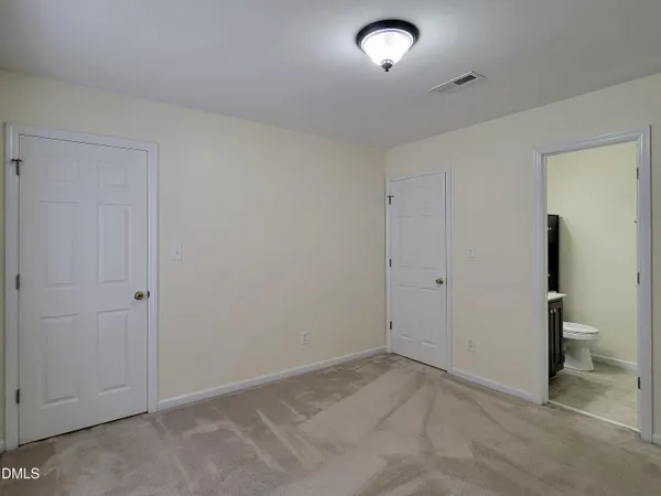 a bathroom with a granite countertop toilet sink and mirror