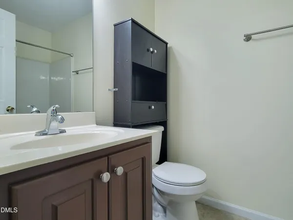 a bathroom with a sink vanity and a mirror