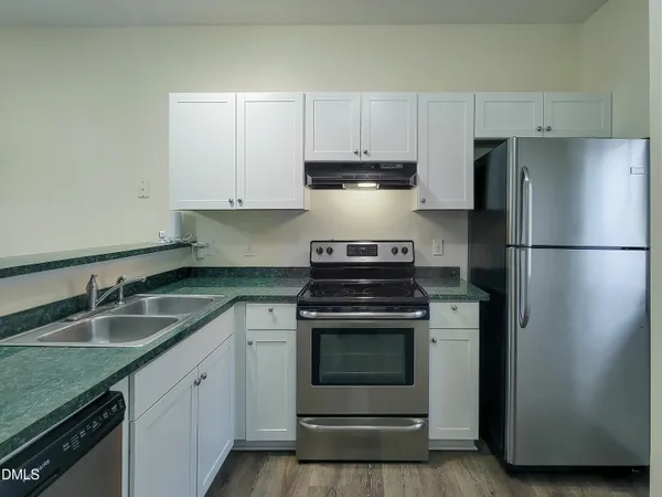 a kitchen with a sink stove and refrigerator