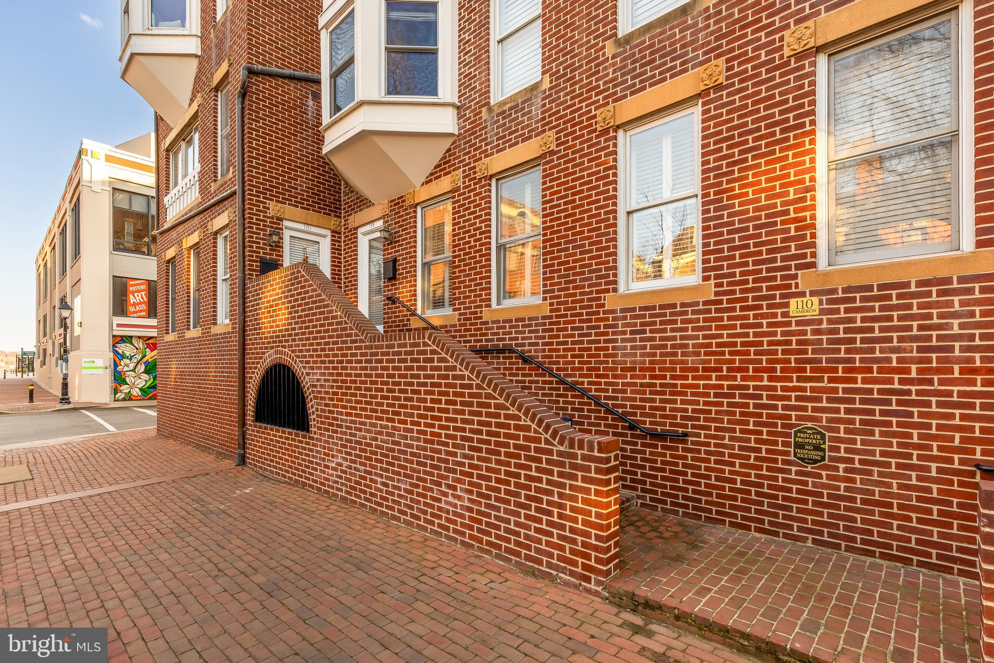 110 Cameron Street, Unit CS102 Alexandria, VA 22314 - Photo 12 of 24 a view of a brick building with many windows