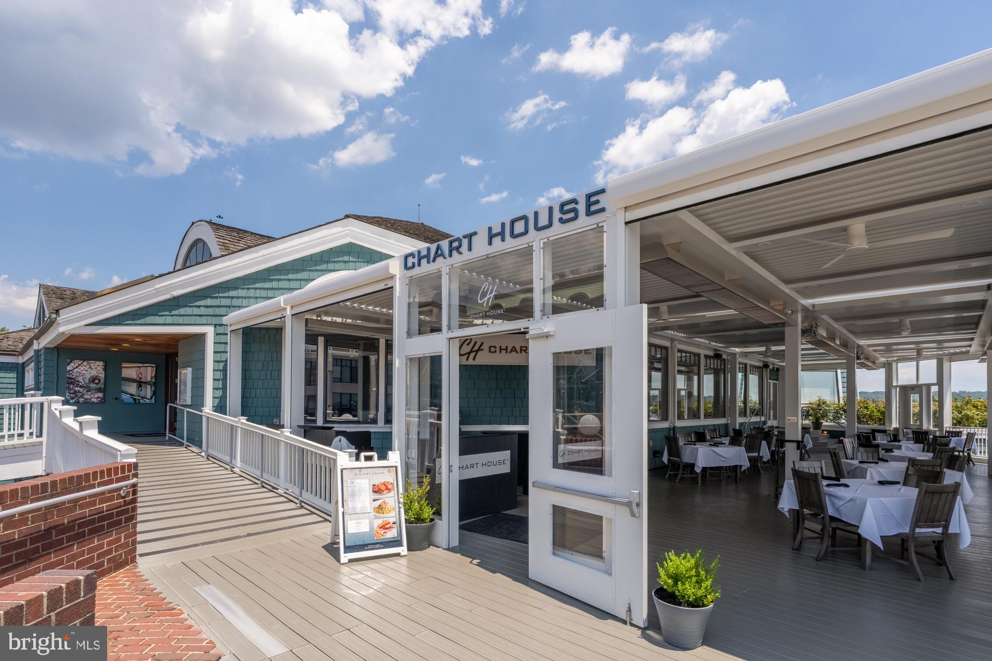 110 Cameron Street, Unit CS102 Alexandria, VA 22314 - Photo 19 of 24 a view of a patio with dining table and chairs with wooden floor