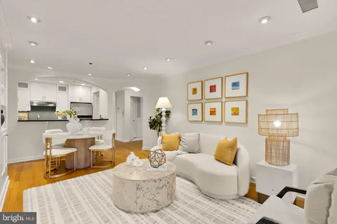 a living room with furniture kitchen and a table