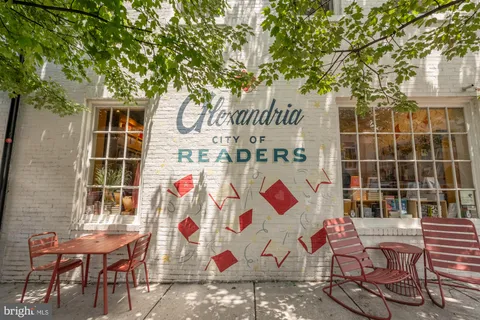 a view of a patio with dining table and chairs with wooden floor