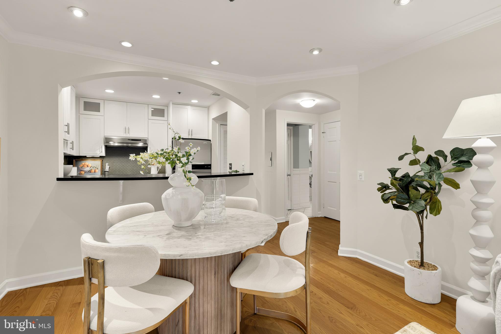 110 Cameron Street, Unit CS102 Alexandria, VA 22314 - Photo 3 of 24 a view of a dining room with furniture and wooden floor