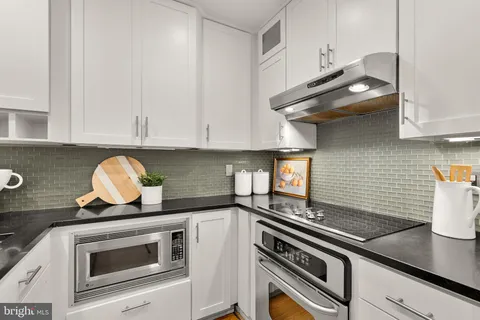 a kitchen with granite countertop a stove and a sink