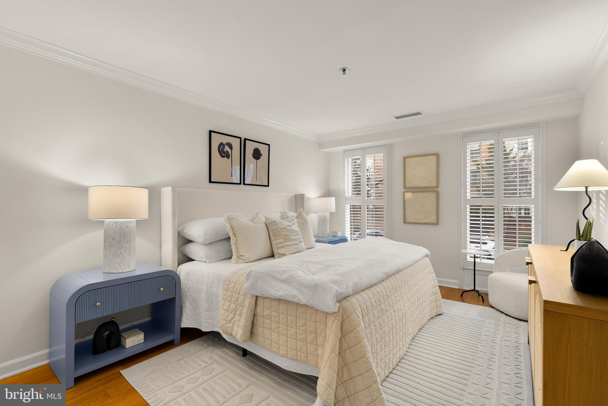 110 Cameron Street, Unit CS102 Alexandria, VA 22314 - Photo 6 of 24 a bedroom with a bed and wooden floor