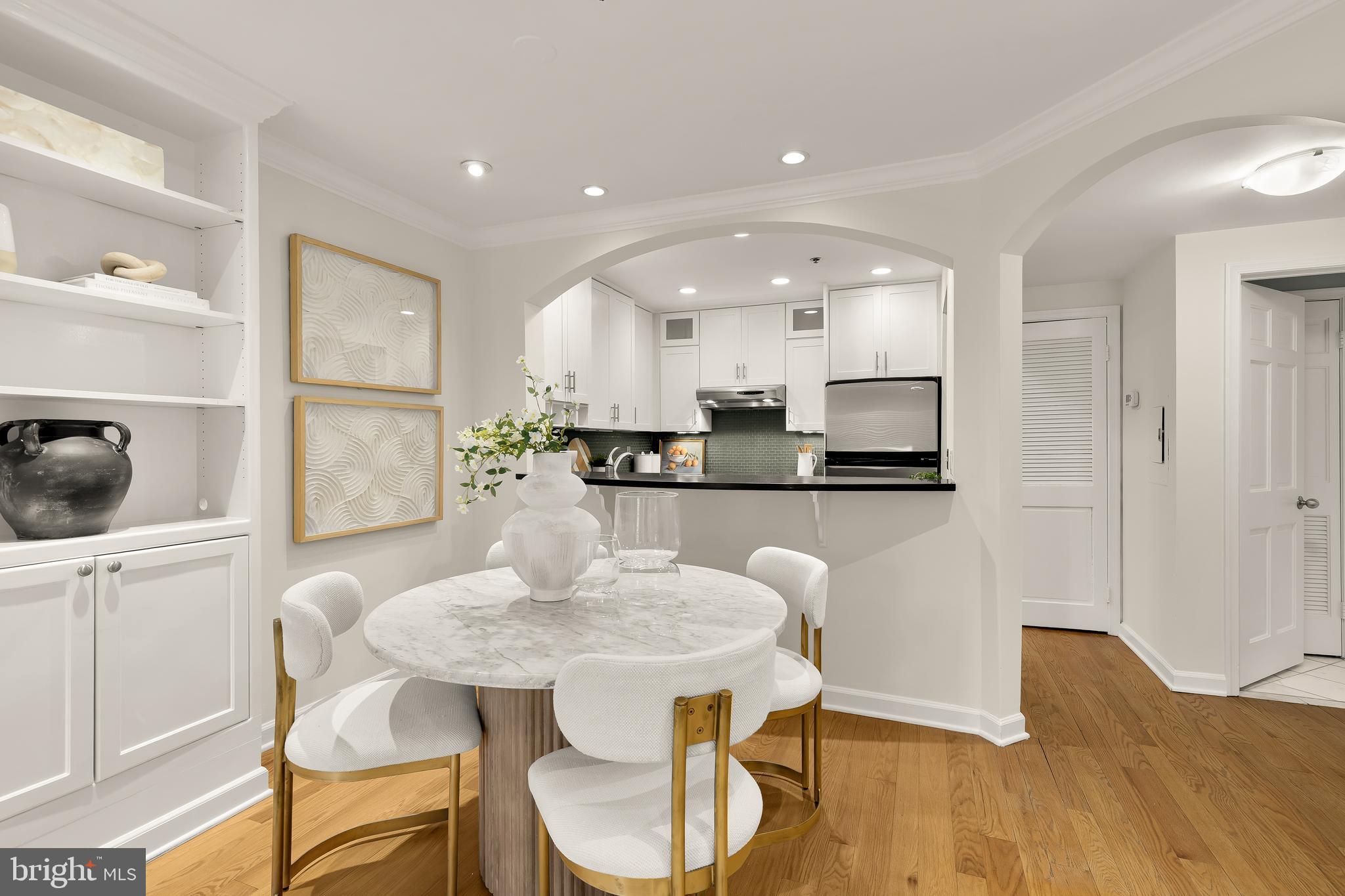 110 Cameron Street, Unit CS102 Alexandria, VA 22314 - Photo 24 of 24 a kitchen with kitchen island a dining table and chairs