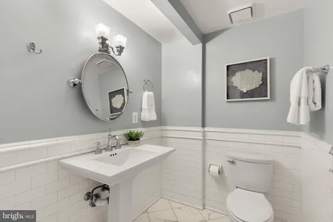 a kitchen with kitchen island a dining table and chairs
