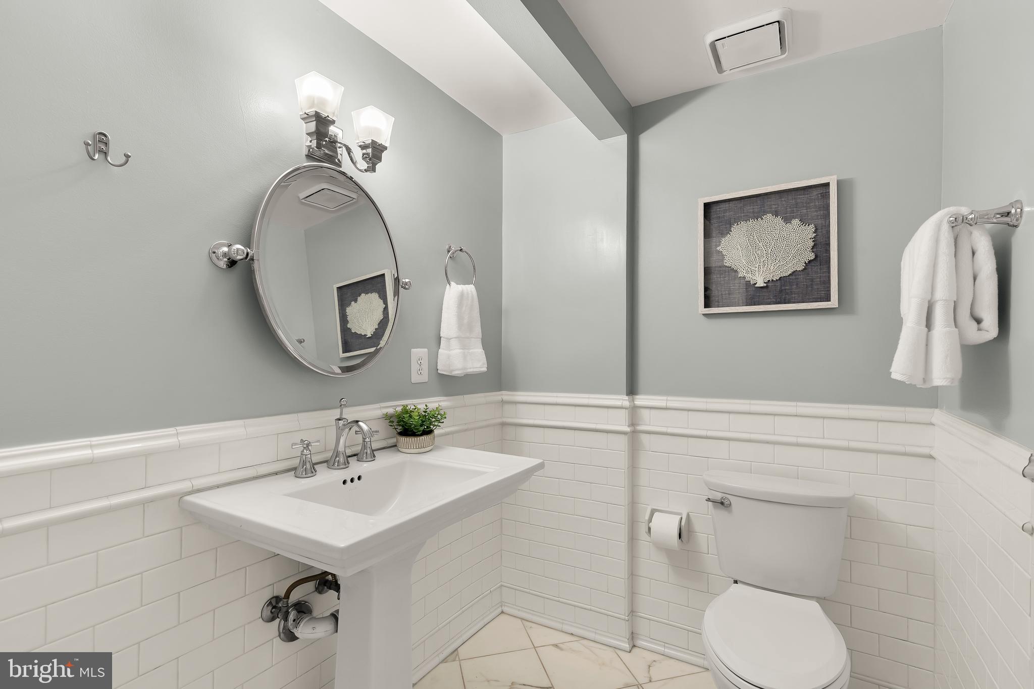 110 Cameron Street, Unit CS102 Alexandria, VA 22314 - Photo 8 of 24 a bathroom with a toilet a sink and mirror