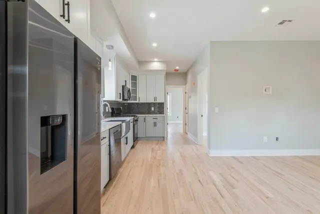a kitchen with a sink and refrigerator