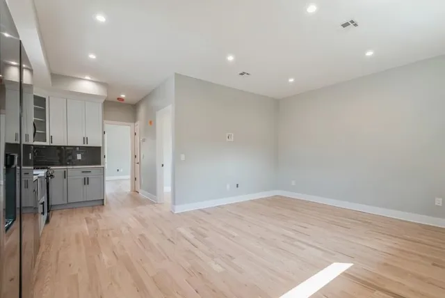 a view of kitchen with stainless steel appliances cabinets and wooden floor