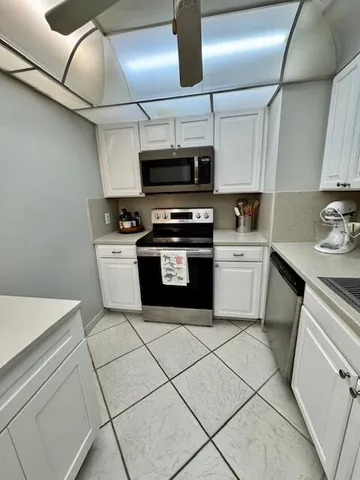 a kitchen with stainless steel appliances granite countertop a sink and a stove