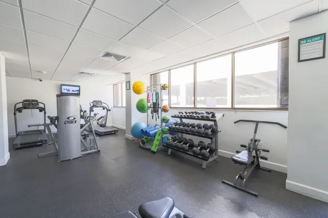 a dining room with furniture a chandelier and a rug