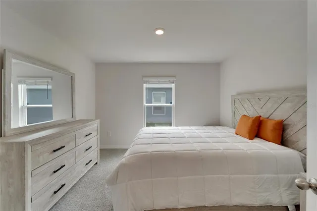 a room with a bed and a dresser