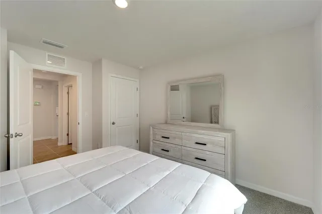 a bedroom with a bed and a mirror