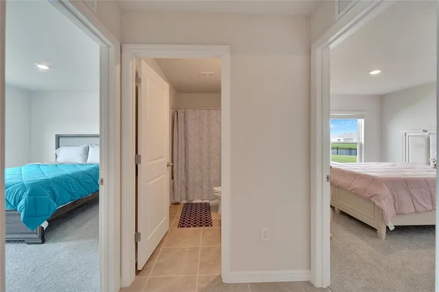 a bedroom with a bed and a mirror