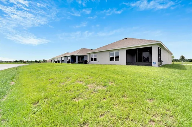 a view of a city with lawn chairs and large trees