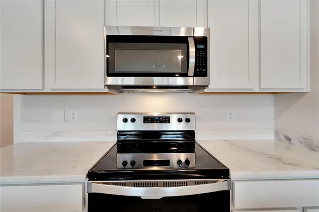 a kitchen with a refrigerator and cabinets