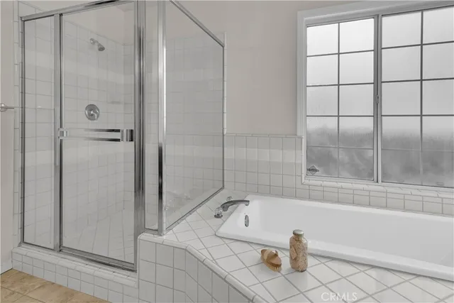 a bathroom with a bathtub and shower