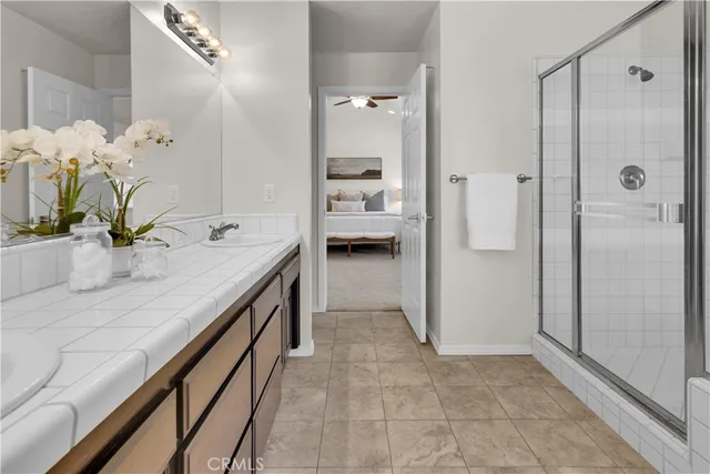 a bathroom with a double vanity sink a mirror and a shower