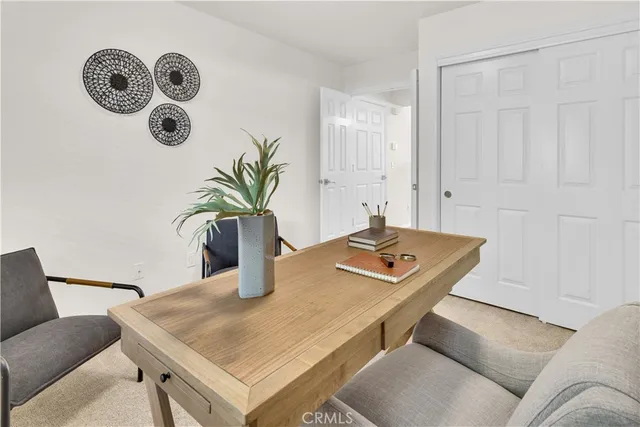 a living room with kitchen island furniture and a potted plant