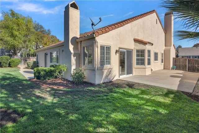 a view of a house with a yard and plants