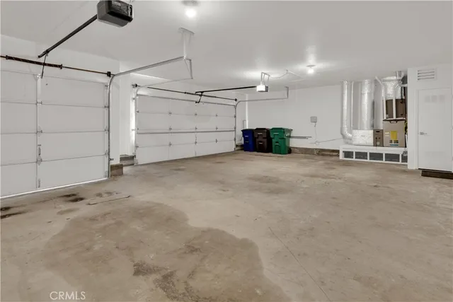 an empty room with ceiling fan and windows