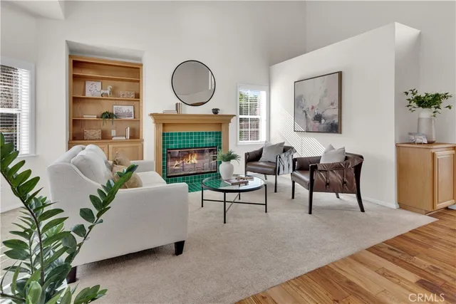 a living room with furniture a fireplace and a potted plant