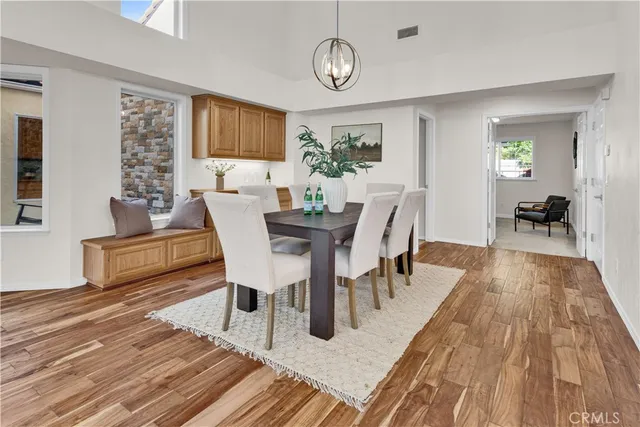 a view of a dining room with furniture window and wooden floor