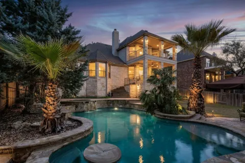 a view of a house with swimming pool and a yard