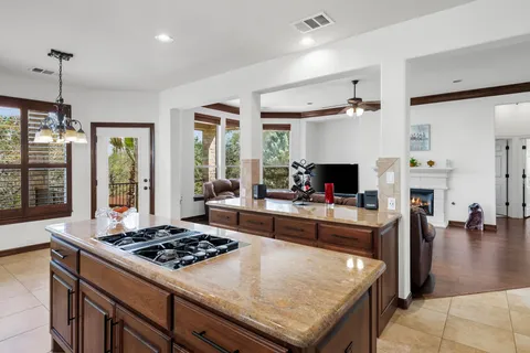 a large kitchen with a stove and a refrigerator