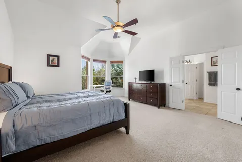 a bedroom with a bed and a large window
