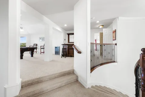 a view of a hallway with furniture and a living room