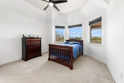 a bedroom with a bed and a baby crib