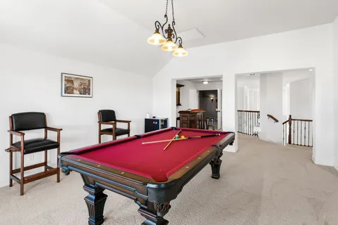 a room with pool table and windows