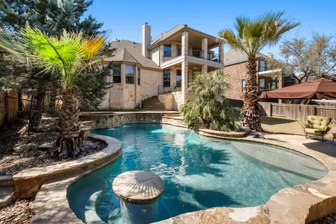 a swimming pool with outdoor seating and yard