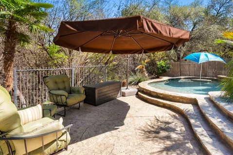 a patio with a patio table and chairs under an umbrella