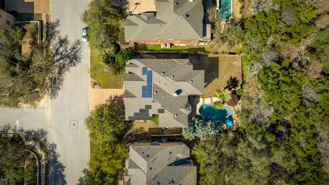 an aerial view of residential houses with outdoor space