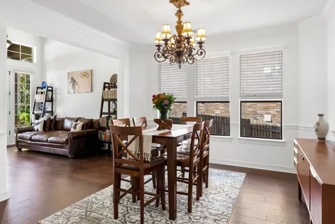 a view of a dining room with furniture wooden floor and chandelier