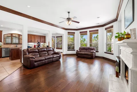 a living room with fireplace furniture and a large window