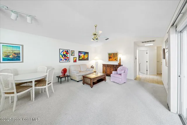 a bedroom with furniture and a chandelier fan