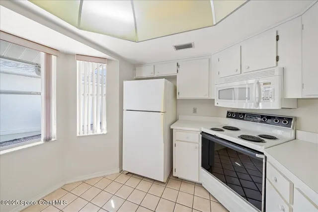 a kitchen with a stove cabinets and refrigerator