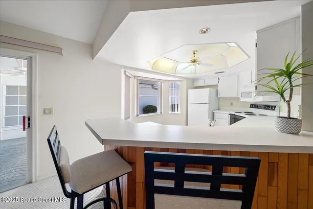 a view of a dining room with furniture and a chandelier