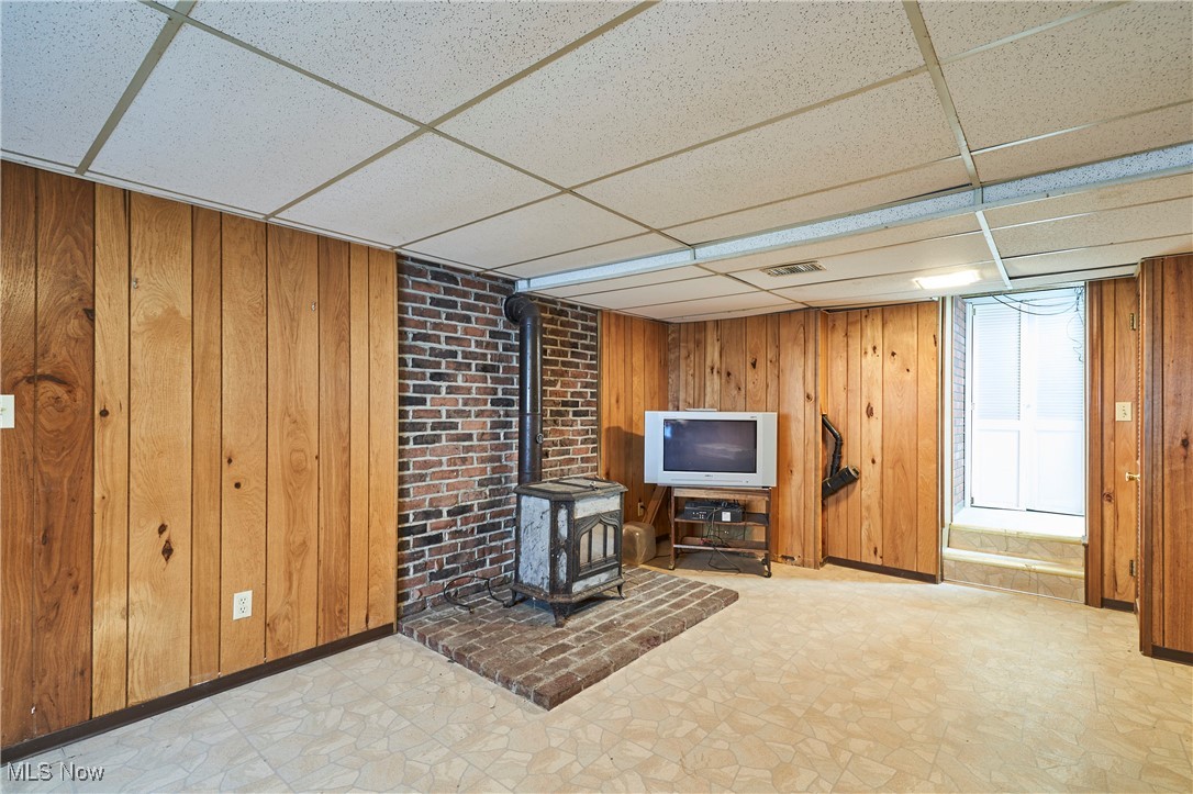 2610 Shade Road Akron, OH 44333 - Photo 27 of 45 Rec room with paneled wall, walks up to the patio and back yard. There also is the fourth bathroom located in the lower level- However, seller has never used it