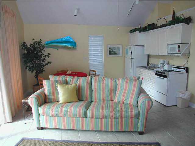 Nantucket Cottage, Unit 6 Destin, FL 32541 - Photo 5 of 10 a bedroom with a bed and a couch