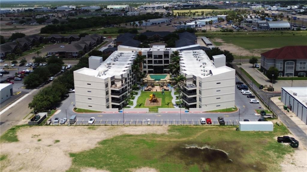 813 Travis Street, Unit 203 Mission, TX 78572 - Photo 28 of 30 an aerial view of a house with a garden and lake view