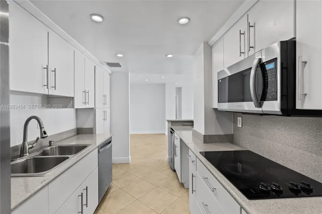 a view of a swimming pool with a lawn chairs and palm trees