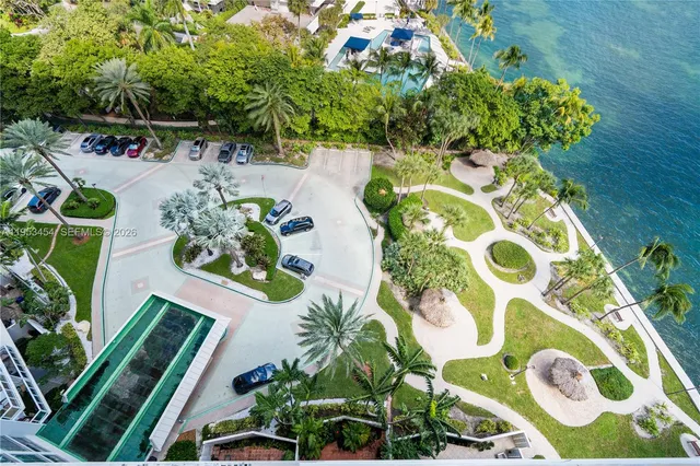a bathroom with a sink shower and a mirror