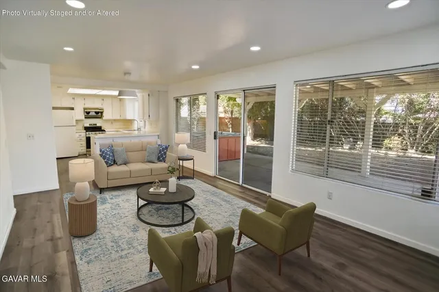 a living room with furniture and a floor to ceiling window